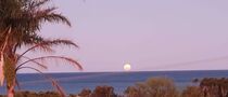 Full moon in Valeidia, the moon having a pink tint to it by the sunset.