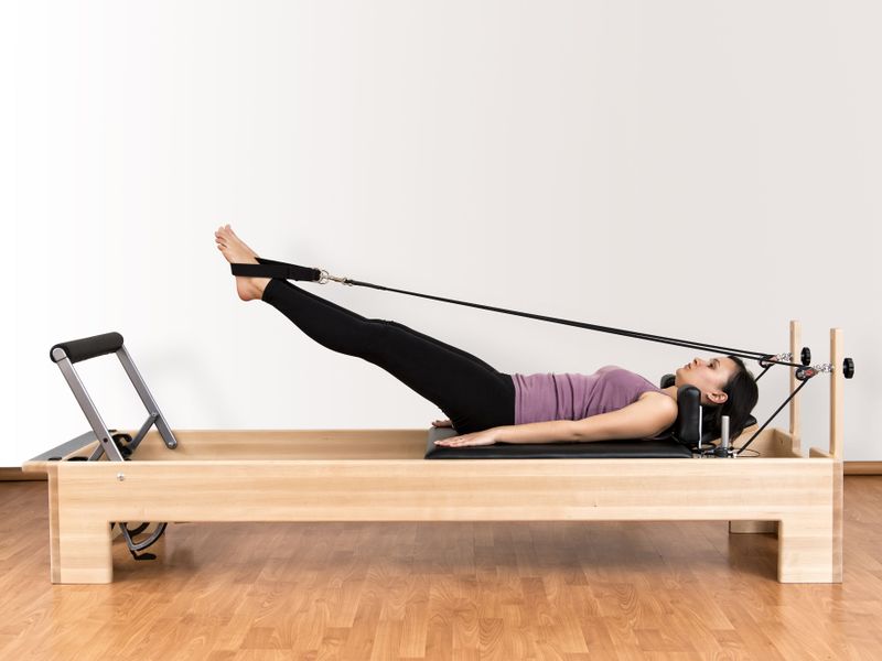 File:Working-pilates-on-reformer-bed.jpg