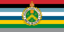 A flag with the colours of the various branches of the Urabbaparcensian Defence Service defaced with the insignia of Urabba Parks